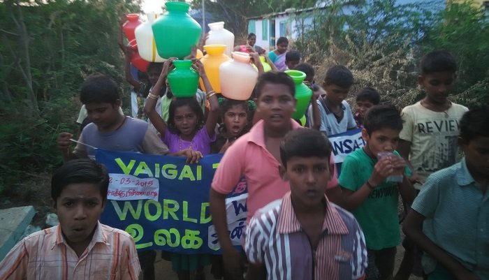 Children with VAIGAI banners at an awareness event