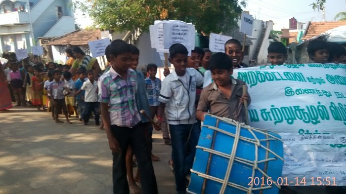 Awareness rally with banners and drum in the village