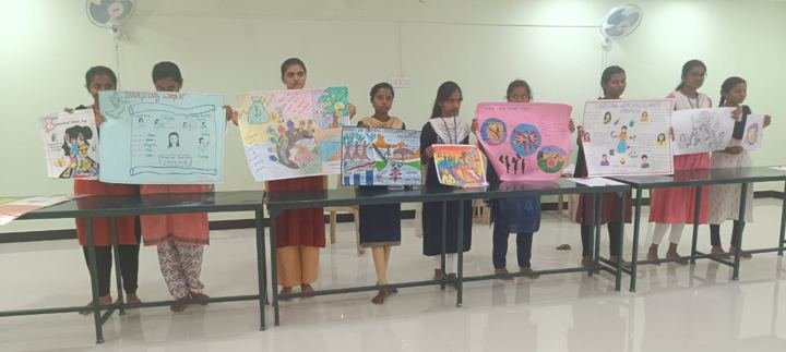 Girls with posters in a classroom