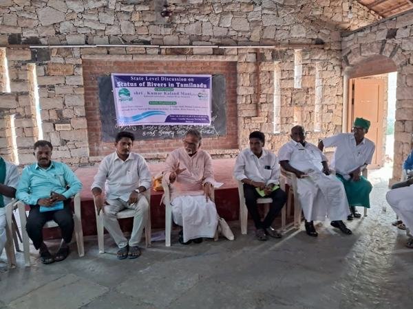 Seminar in a hall with speakers seated at the front